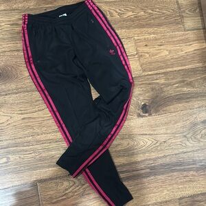 Adidas leggings, black with bright pink triple stripes, and two zip up pockets